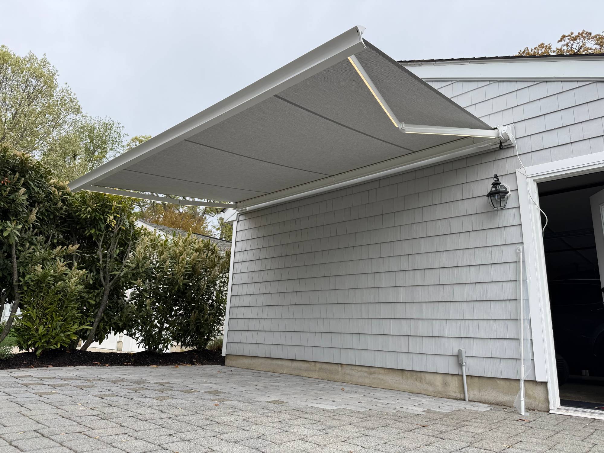 A Salute awning extended at dusk with the optional integrated LED arms lit